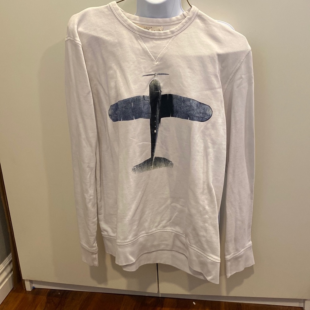 L sweater Label of Graded Goods. Off white long sleeve with an airplane as deco